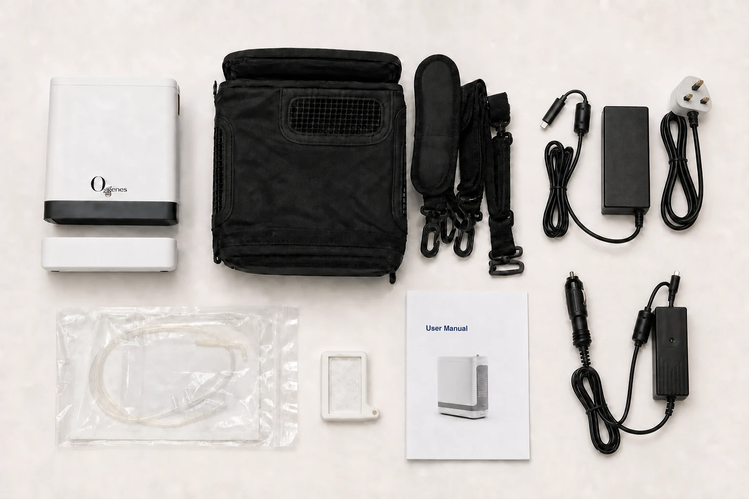 POC kit with main unit, normally positioned full-base battery, opaque carry case, straps, AC adapter, vehicle adapter, cannula, filter, and manual